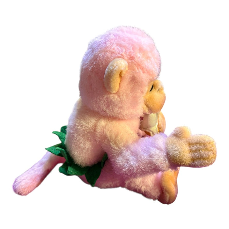 Vintage Preowned Royal Plush Pink Monkey Eating a Banana and Wearing a Leafy Green Skirt